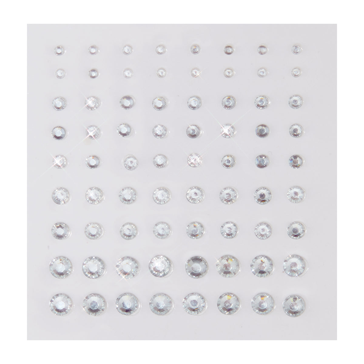 Clear round rhinestone stickers in graduated sizes sparkle on a white backing sheet, arranged in neat rows; ColourPop Crystal Face Jewels, Individual pack, self-adhesive crystals for customizable face and eye makeup looks.