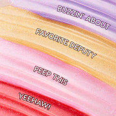 Four shimmering swatches display Squad Dreams ColourPop Ultra Glossy Lip - lavender Buzzin’ About, golden Favorite Deputy, baby‑pink Peep This, and cherry red Yeehaw! - swept in wide bands to showcase sparkle and high‑shine finish.