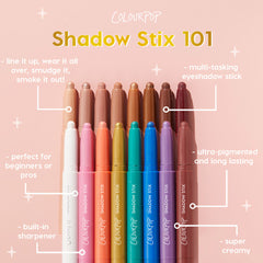 ColourPop Shadow Stix Hey Boo eyeshadow stick shown among a rainbow lineup, tips uncapped to display creamy, ultra-pigmented shades; multi-tasking stick with a built-in sharpener for lining, smudging, or all-over wear on a soft pink backdrop.
