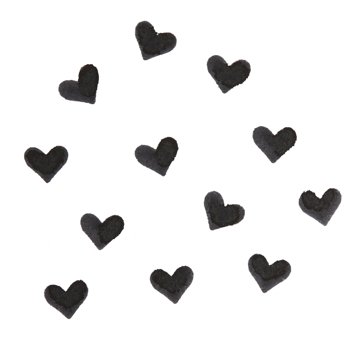 Black heart-shaped swatches stamped by the Heart Face Stamp, showing opaque, crisp pigment on a white background; ColourPop Face Stamp swatch pattern highlighting payoff.
