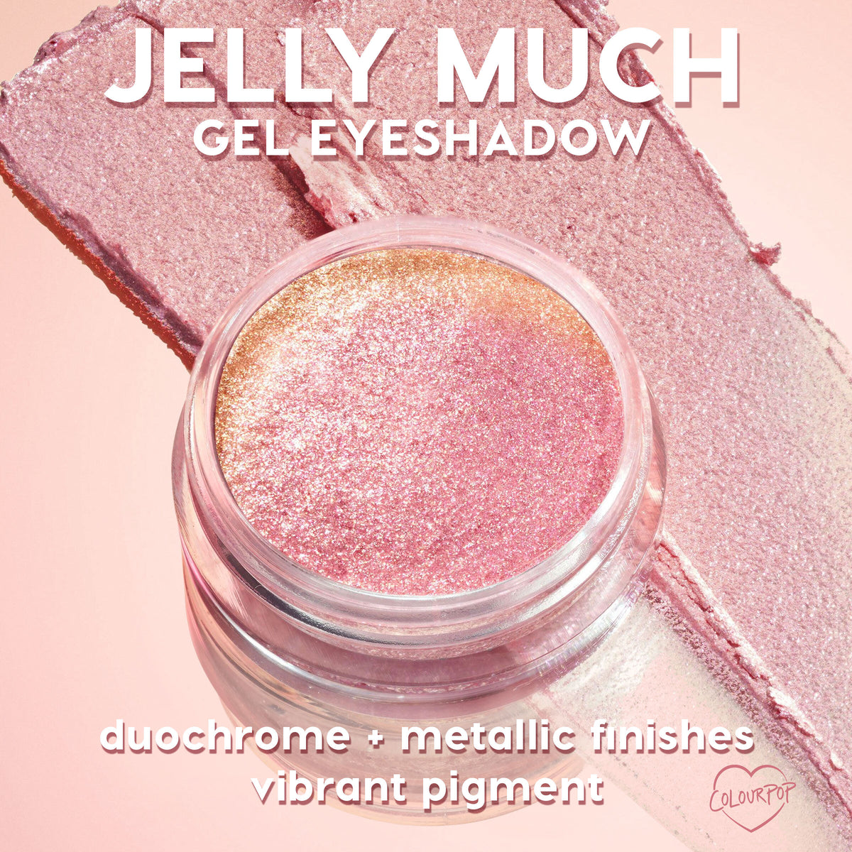 Open jar of ColourPop Jelly Much Shadow Big Ego shimmering pink‑to‑gold duochrome gel eyeshadow, catching light as it sits atop matching swatches, showcasing metallic finish and vibrant pigment on a soft pink background.