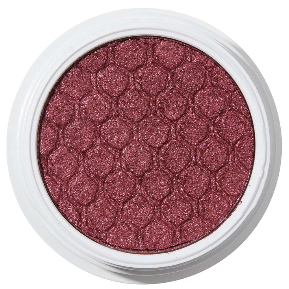 ColourPop Drift Super Shock Shadow displays a metallic cranberry-burgundy shimmer, pressed with a quilted scale pattern, sitting in a round white pot on a plain white studio background.