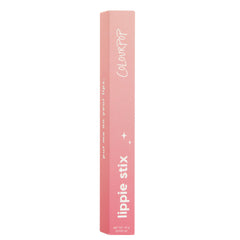 ColourPop Lippie Stix Primer stands upright, a pink ombré rectangular box displaying white “lippie stix” and “ColourPop” text with small star icons and net wt. 1.0 g (0.035 oz), set against a clean white background.